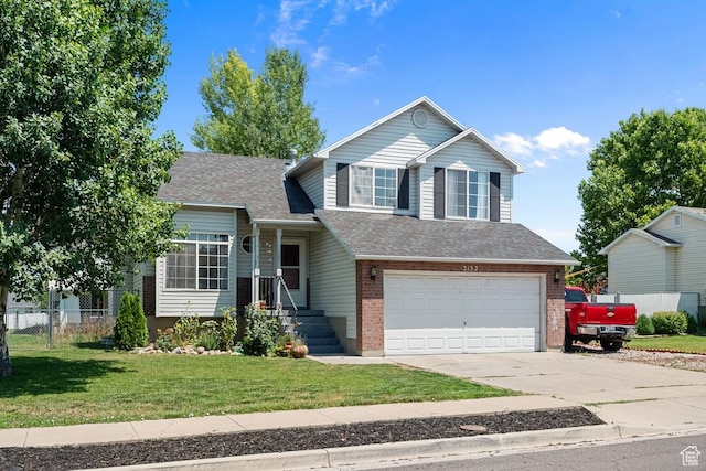 2132 W 2175 N, Clinton, UT 84015 - split level home featuring an attached garage, concrete driveway, brick siding, and roof with shingles