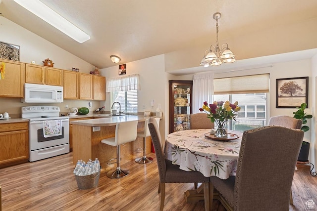 2132 W 2175 N, Clinton, UT 84015 - kitchen with white appliances, lofted ceiling, a chandelier, light countertops, and a kitchen breakfast bar