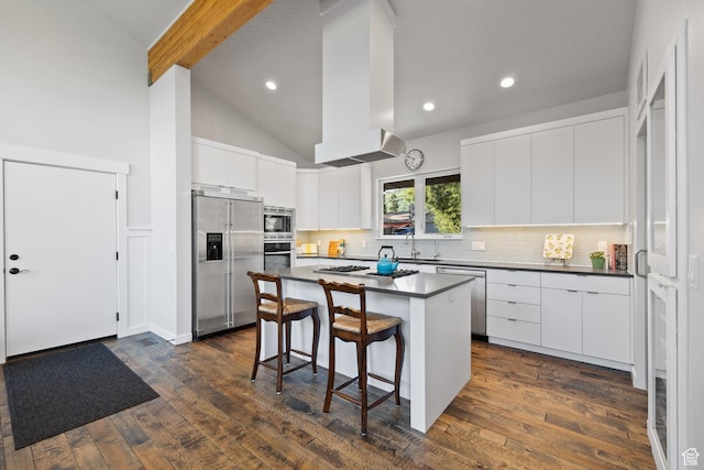 249 S Parkview Dr E, Park City, UT 84098 - kitchen with appliances with stainless steel finishes, dark countertops, a breakfast bar, tasteful backsplash, and a center island