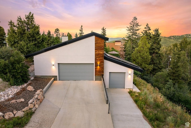 249 S Parkview Dr E, Park City, UT 84098 - contemporary home with a chimney, stucco siding, and a detached garage