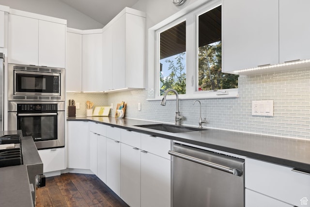 249 S Parkview Dr E, Park City, UT 84098 - kitchen featuring stainless steel appliances, dark wood-type flooring, vaulted ceiling, dark countertops, and white cabinets