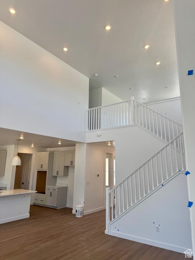 1001 E 250 S, Salem, UT 84653 - unfurnished living room with a high ceiling, dark wood-style floors, stairway, and recessed lighting