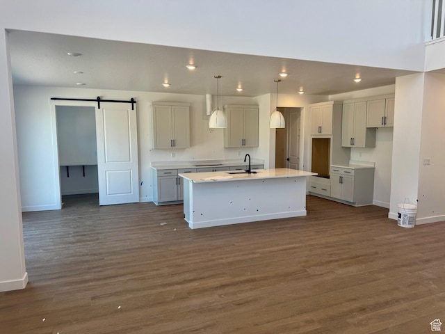 1001 E 250 S, Salem, UT 84653 - kitchen with a kitchen island with sink, dark wood-style floors, a barn door, stovetop, and recessed lighting
