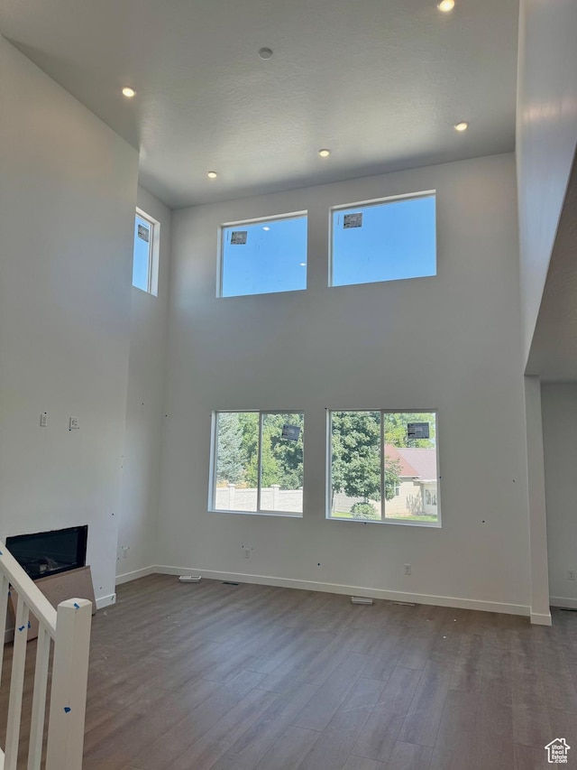 1001 E 250 S, Salem, UT 84653 - unfurnished living room with a high ceiling, wood finished floors, and recessed lighting