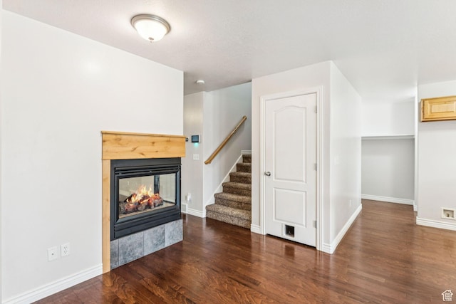 631 E Clearwater Dr, Layton, UT 84041 - unfurnished living room with a multi sided fireplace, wood finished floors, and stairs