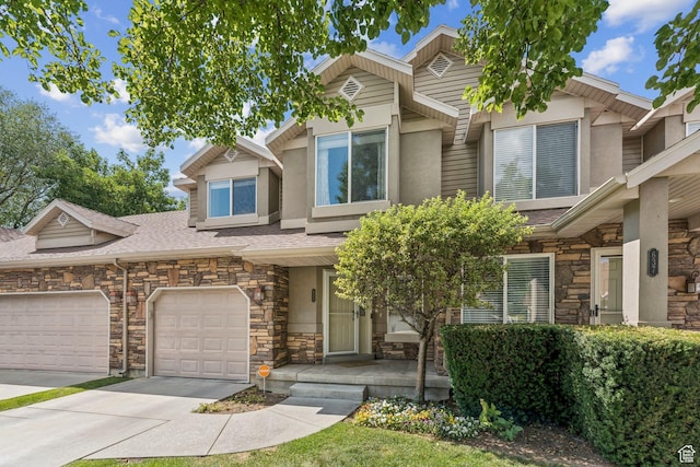 631 E Clearwater Dr, Layton, UT 84041 - view of front of home featuring stone siding, stucco siding, driveway, and covered porch