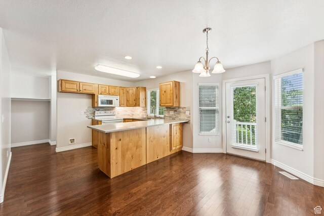 631 E Clearwater Dr, Layton, UT 84041 - kitchen with white appliances, a peninsula, light countertops, plenty of natural light, and recessed lighting