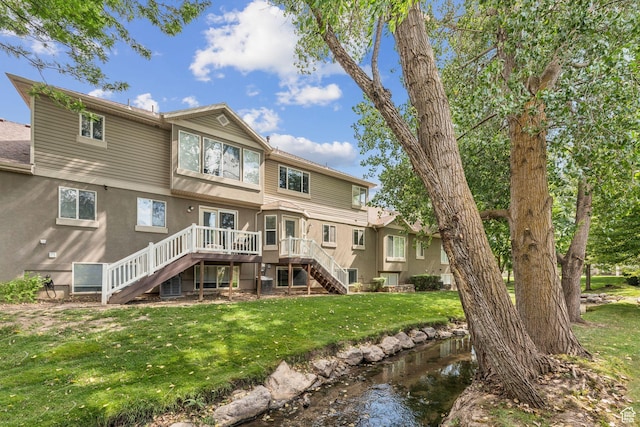 631 E Clearwater Dr, Layton, UT 84041 - back of property featuring stairway, a wooden deck, and a yard