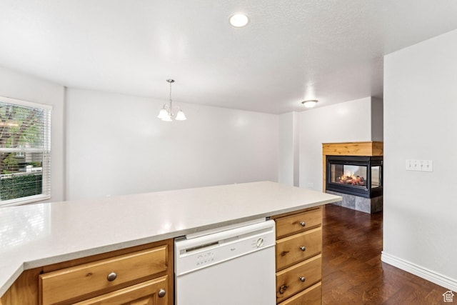 631 E Clearwater Dr, Layton, UT 84041 - kitchen with dishwasher, dark wood-type flooring, light countertops, a multi sided fireplace, and hanging light fixtures