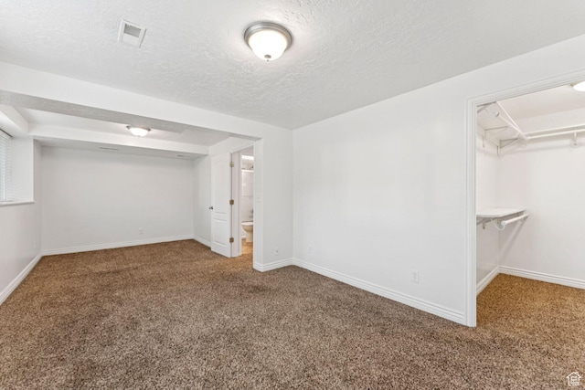 631 E Clearwater Dr, Layton, UT 84041 - unfurnished bedroom with carpet floors, a walk in closet, and a textured ceiling
