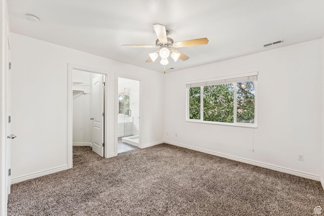 631 E Clearwater Dr, Layton, UT 84041 - unfurnished bedroom featuring carpet flooring, a walk in closet, connected bathroom, and a ceiling fan
