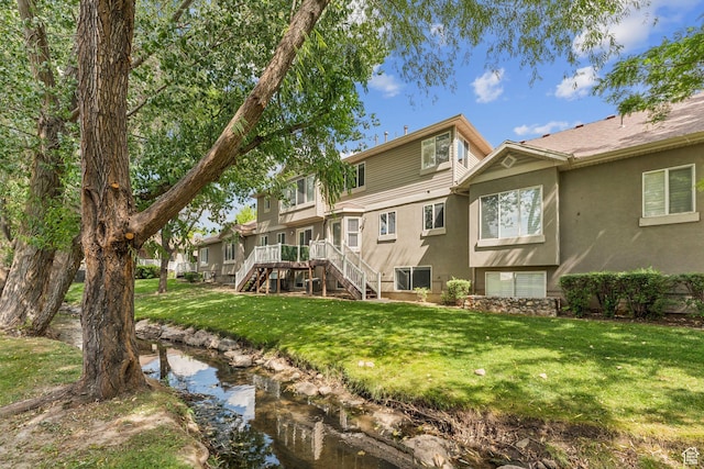631 E Clearwater Dr, Layton, UT 84041 - back of property with stucco siding, stairway, and a lawn