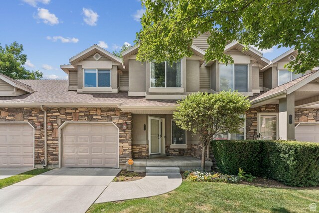 631 E Clearwater Dr, Layton, UT 84041 - traditional-style house featuring stone siding, concrete driveway, stucco siding, a garage, and a front lawn