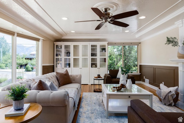 2400 E Logan Way S, Salt Lake City, UT 84108 - living area featuring wood finished floors, a wainscoted wall, a decorative wall, crown molding, and ceiling fan