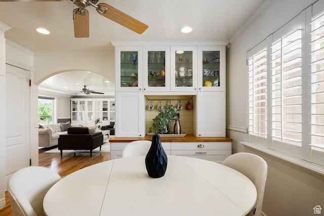 2400 E Logan Way S, Salt Lake City, UT 84108 - dining space featuring ceiling fan, crown molding, wood finished floors, arched walkways, and recessed lighting