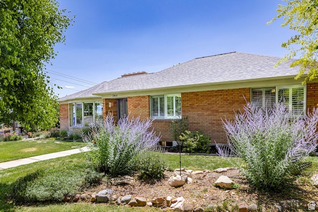2400 E Logan Way S, Salt Lake City, UT 84108 - ranch-style house featuring brick siding, a front yard, and a shingled roof