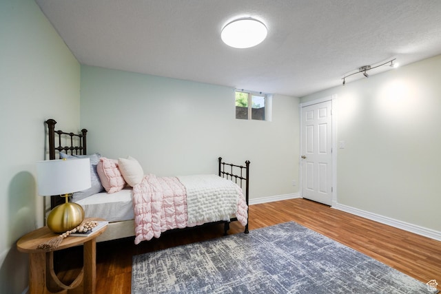 2400 E Logan Way S, Salt Lake City, UT 84108 - bedroom featuring wood finished floors and a textured ceiling