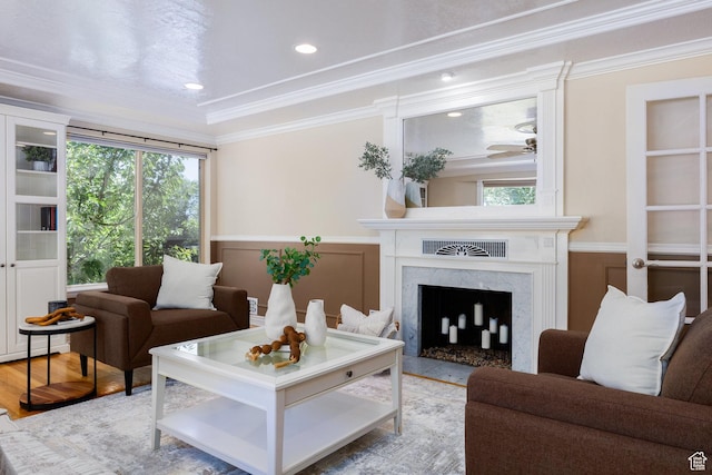 2400 E Logan Way S, Salt Lake City, UT 84108 - living room with ornamental molding, a high end fireplace, healthy amount of natural light, wainscoting, and wood finished floors