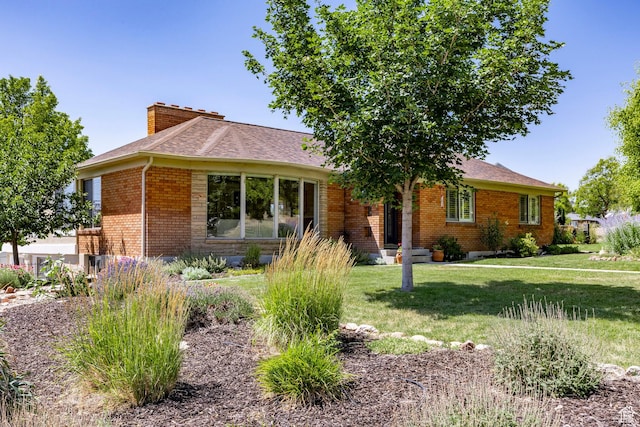 2400 E Logan Way S, Salt Lake City, UT 84108 - ranch-style house with brick siding, a chimney, a front yard, and roof with shingles