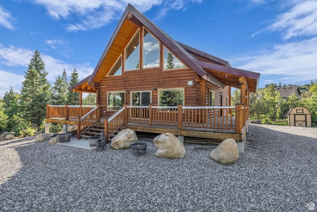 14961 N 12740 E, Mount Pleasant, UT 84647 - view of front of house with log siding, a deck, and a shed