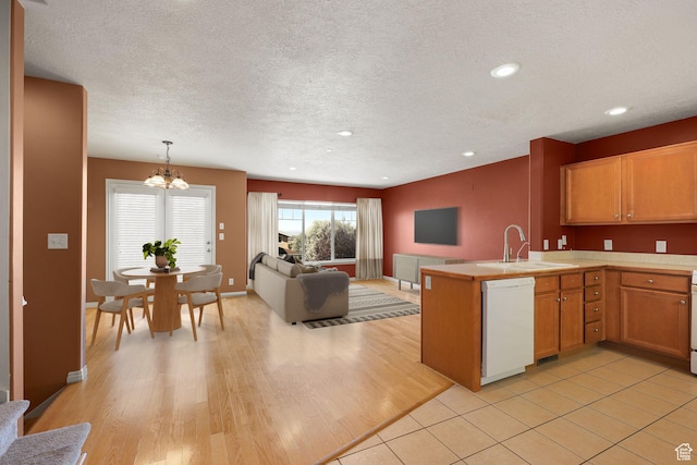1339 Alpine Way, Provo, UT 84606 - kitchen featuring dishwasher, a chandelier, open floor plan, light countertops, and a peninsula