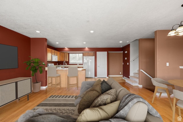 1339 Alpine Way, Provo, UT 84606 - living room with light wood-style flooring, stairway, a textured ceiling, and recessed lighting