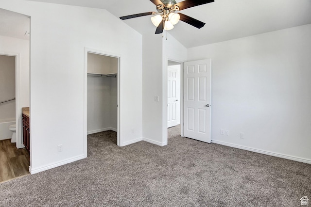 8048 W Copperfield Pl # 31, Magna, UT 84044 - unfurnished bedroom featuring carpet, vaulted ceiling, a spacious closet, and a ceiling fan