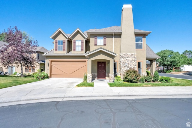 960 E 6740 S, Midvale, UT 84047 - view of front facade with stucco siding, stone siding, concrete driveway, a garage, and a chimney
