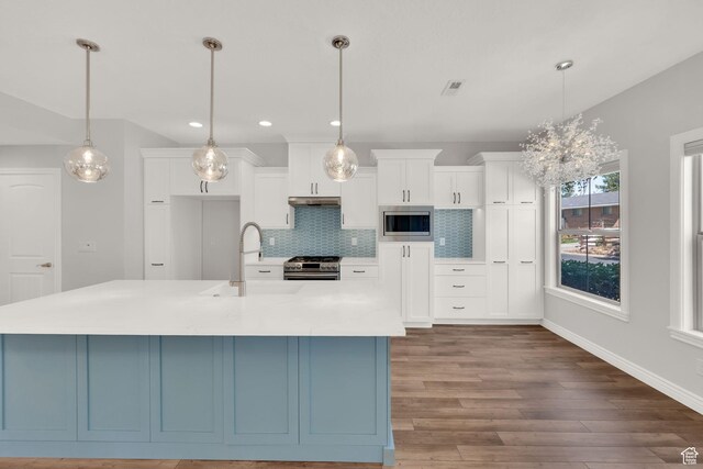 960 E 6740 S, Midvale, UT 84047 - kitchen with stainless steel appliances, white cabinets, tasteful backsplash, wood finished floors, and recessed lighting