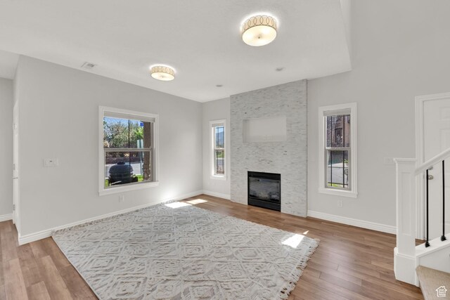 960 E 6740 S, Midvale, UT 84047 - unfurnished living room with wood finished floors, a large fireplace, and stairs