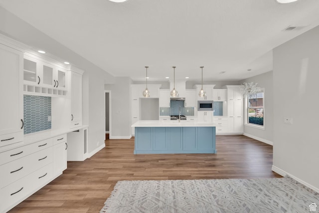 960 E 6740 S, Midvale, UT 84047 - kitchen with decorative backsplash, stainless steel microwave, white cabinets, light countertops, and recessed lighting