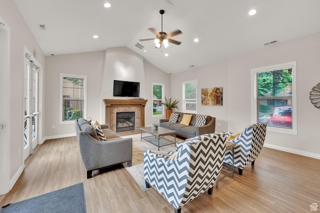 960 E 6740 S, Midvale, UT 84047 - living room with light wood-type flooring, a ceiling fan, a tiled fireplace, lofted ceiling, and recessed lighting