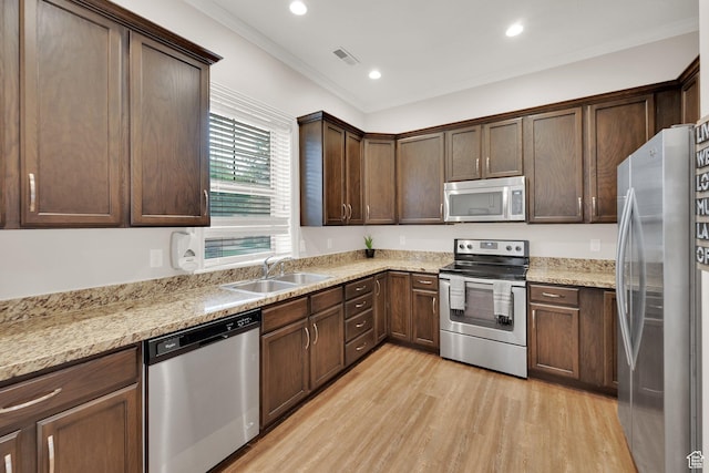 960 E 6740 S, Midvale, UT 84047 - kitchen featuring stainless steel appliances, light wood finished floors, recessed lighting, crown molding, and dark brown cabinetry