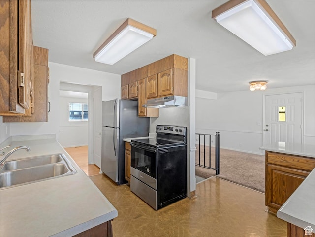 828 E Hibiscus Ave, Sandy, UT 84094 - kitchen with stainless steel appliances, under cabinet range hood, light countertops, and brown cabinetry