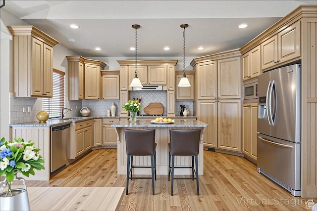 5588 S Farm Hill Dr, Salt Lake City, UT 84117 - kitchen featuring appliances with stainless steel finishes, light wood finished floors, a center island, light stone countertops, and a breakfast bar area