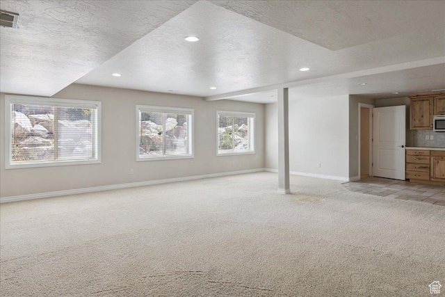 5588 S Farm Hill Dr, Salt Lake City, UT 84117 - basement featuring light carpet, a textured ceiling, and recessed lighting