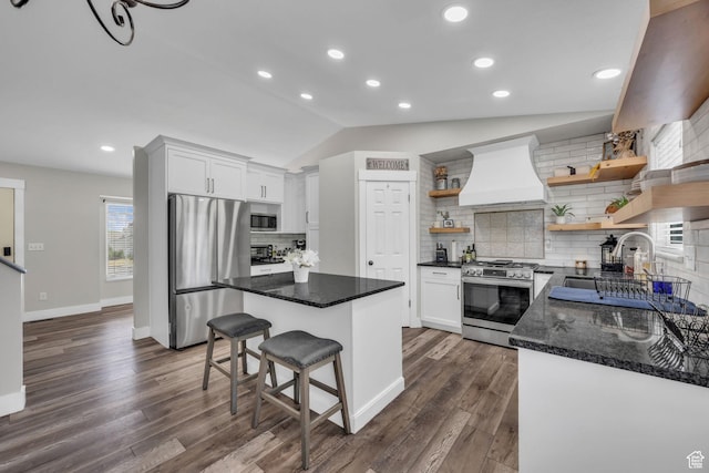 5548 S 3850 W, Roy, UT 84067 - kitchen with appliances with stainless steel finishes, open shelves, premium range hood, lofted ceiling, and tasteful backsplash