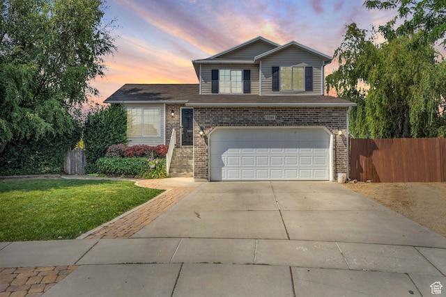5548 S 3850 W, Roy, UT 84067 - view of front of home featuring an attached garage, brick siding, and concrete driveway