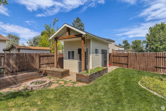5548 S 3850 W, Roy, UT 84067 - view of outdoor structure featuring a garden and a fenced backyard