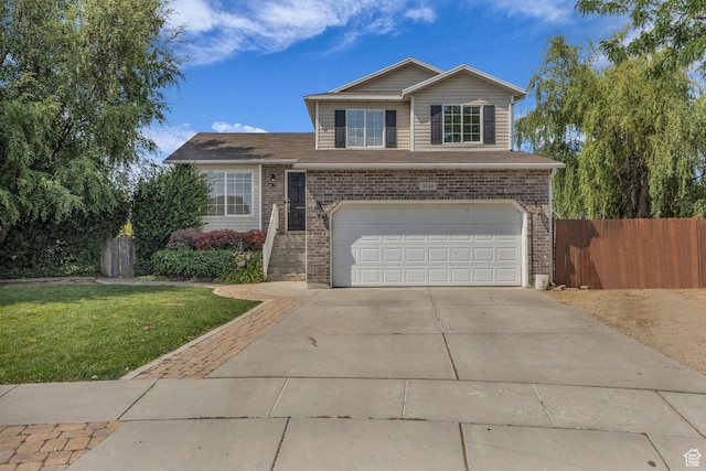 5548 S 3850 W, Roy, UT 84067 - traditional home with an attached garage, brick siding, and driveway