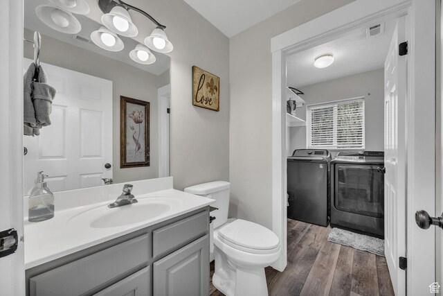 5548 S 3850 W, Roy, UT 84067 - bathroom featuring separate washer and dryer, wood finished floors, and vanity