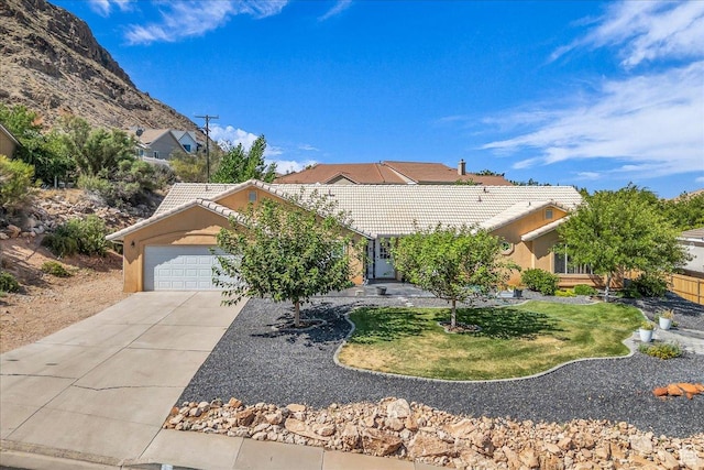 331 W 1910 S, Hurricane, UT 84737 - view of front of home featuring a garage, a tiled roof, driveway, and stucco siding