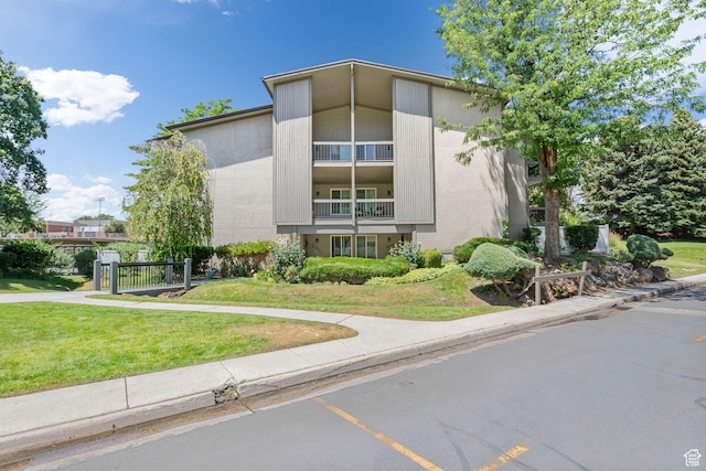 5704 S Waterbury Way Unit H, Murray, UT 84121 - view of property featuring uncovered parking