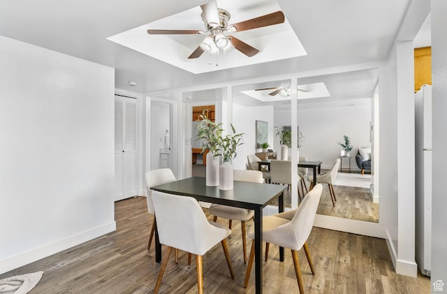 5704 S Waterbury Way Unit H, Murray, UT 84121 - dining room featuring ceiling fan, light wood-style flooring, and a tray ceiling