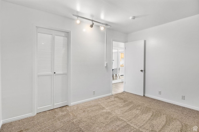 5704 S Waterbury Way Unit H, Murray, UT 84121 - unfurnished bedroom featuring carpet floors, rail lighting, and a closet