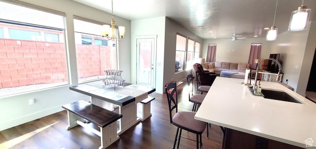 3040 E Lavatera Dr S, St George, UT 84790 - dining space featuring dark wood finished floors, a chandelier, and ceiling fan