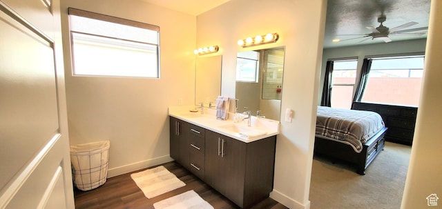3040 E Lavatera Dr S, St George, UT 84790 - bathroom with double vanity, ceiling fan, connected bathroom, and wood finished floors
