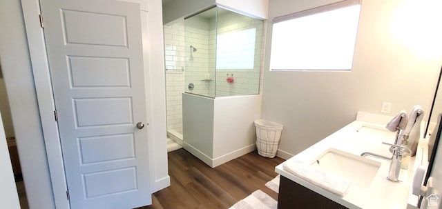 3040 E Lavatera Dr S, St George, UT 84790 - bathroom featuring walk in shower, double vanity, and wood finished floors