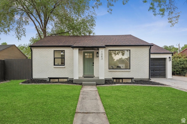 1043 S 1300 W, Salt Lake City, UT 84104 - view of front of home with driveway, brick siding, a shingled roof, and an attached garage