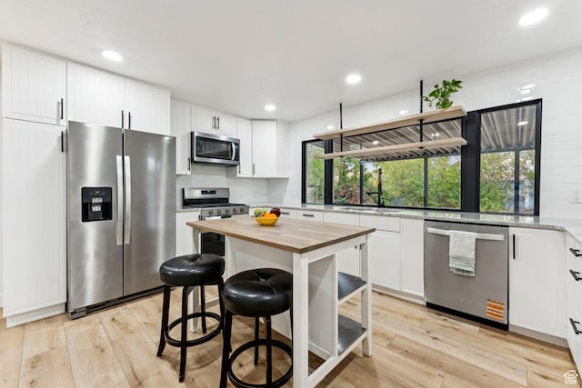 1043 S 1300 W, Salt Lake City, UT 84104 - kitchen with appliances with stainless steel finishes, butcher block counters, decorative backsplash, white cabinets, and recessed lighting